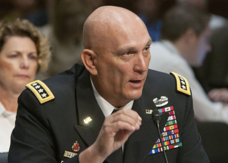 Army Chief of Staff Gen. Raymond T. Odierno prepares to don a Navy football  jersey after